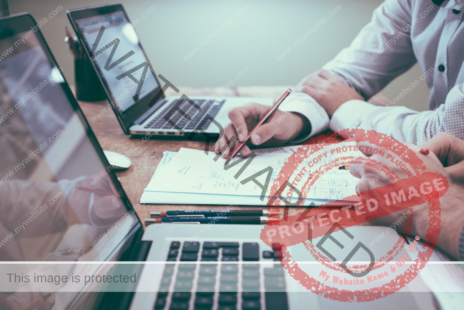 Person Holding Pencil Near Laptop Computer